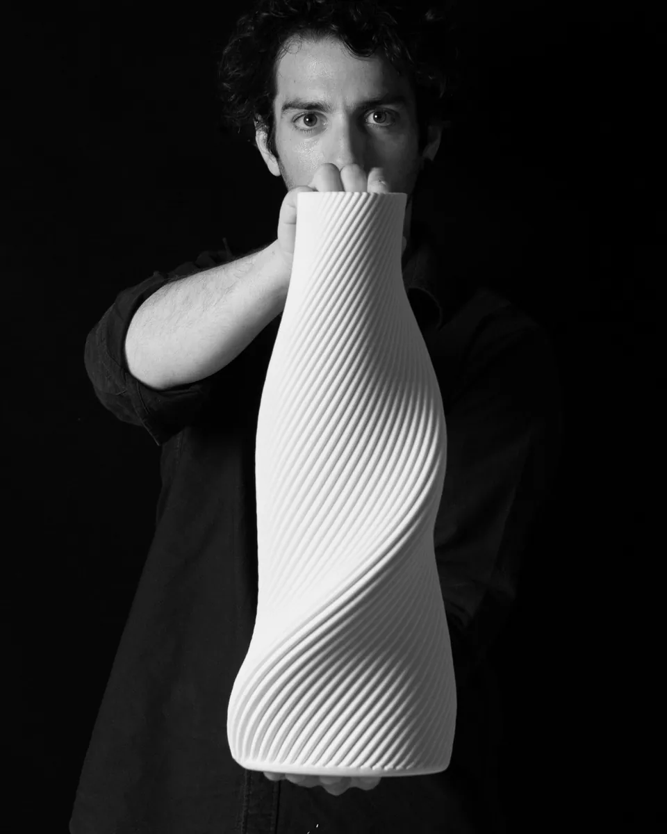 Portrait of Yiannis Vogdanis holding a Tornado sculpture