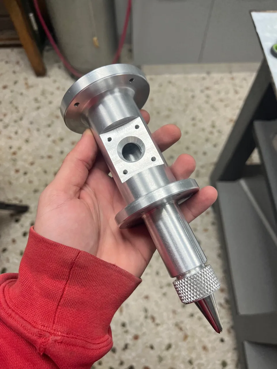 Machined aluminium extruder body held in hand
