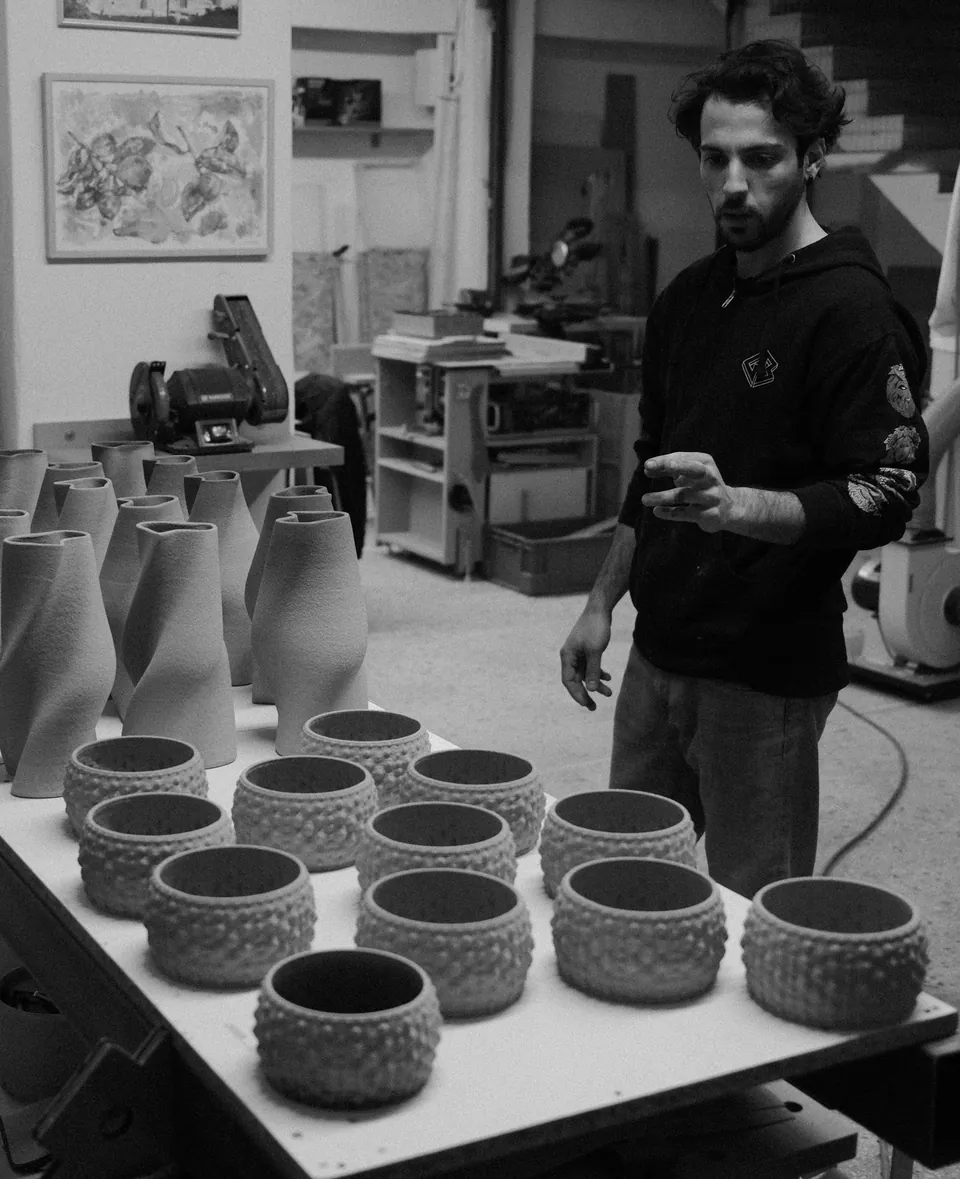 A batch of printed vessels on a studio table
